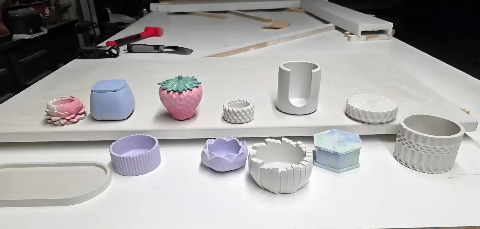 A row of small colorful concrete pieces cast from 3D-printed molds