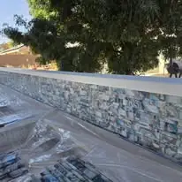 Backsplash &mdash; Stone-look tile under a poured cap.